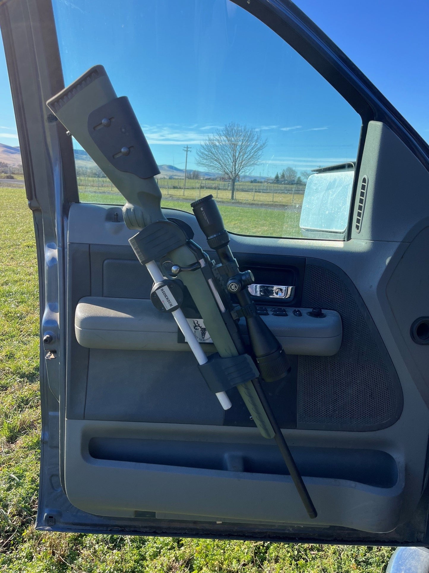 Ruger American Predator rifle safely secured in the Sidekick door mounted vehicle gun rack in a 2006 Ford F150