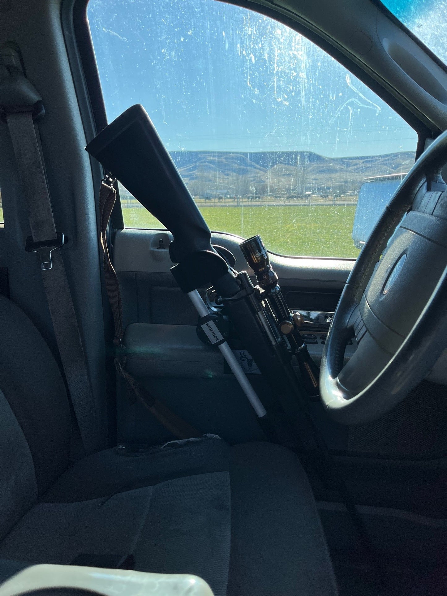 Howa 1500 rifle safely secured in the Sidekick door mounted vehicle gun rack in a 2006 Ford F150