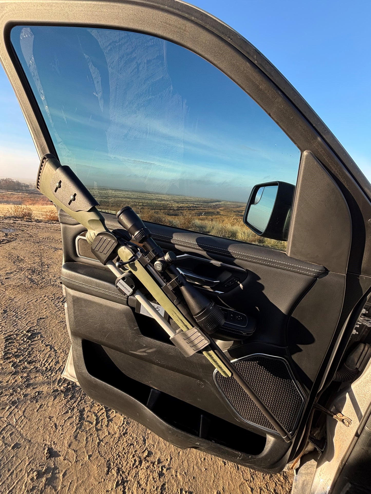 Ruger American Predator rifle safely secured in the Sidekick door mounted vehicle gun rack in a 2022 Ram 1500