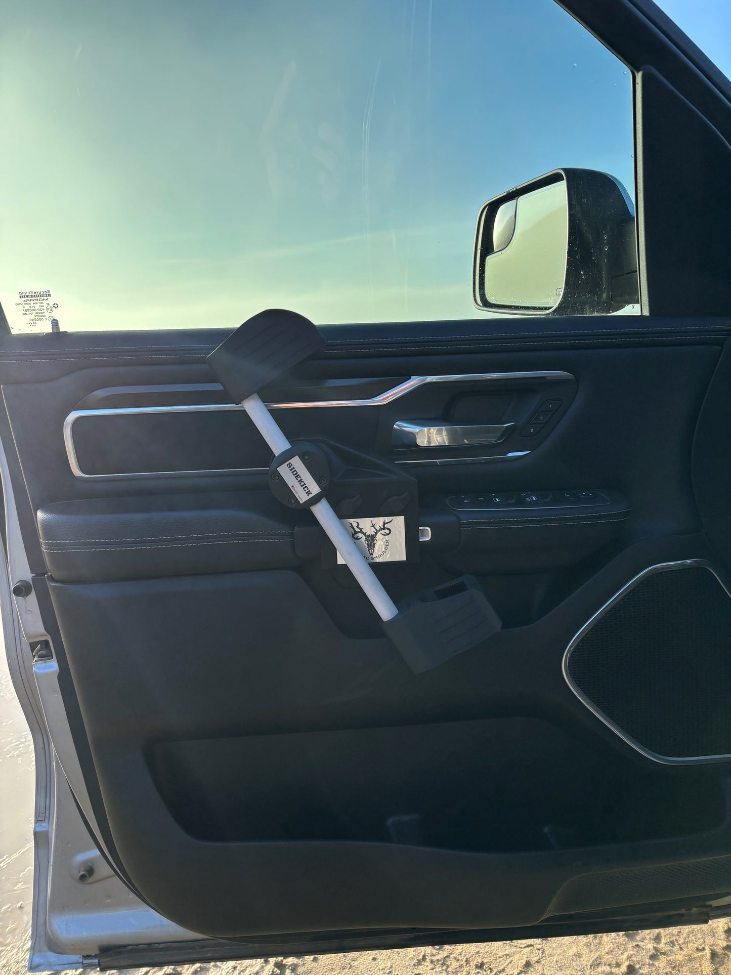Gun rack for vehicle interior, mounts securely to the door handle, providing safe and efficient access to rifles or shotguns while hunting or recreating.