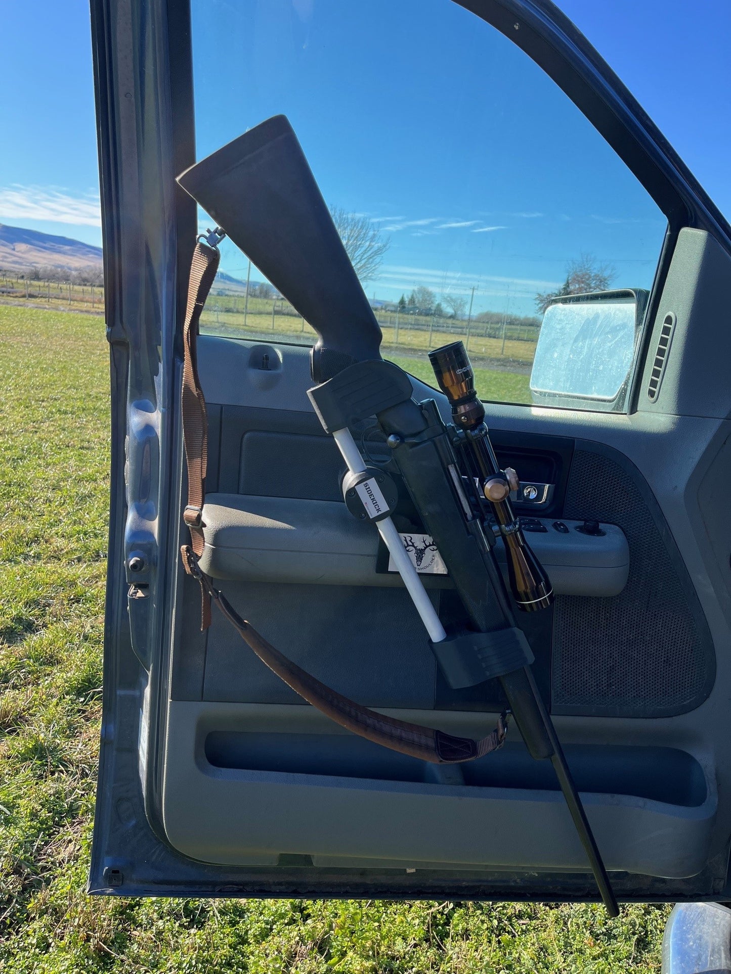 Howa 1500 rifle safely secured in the Sidekick door mounted vehicle gun rack in a 2006 Ford F150